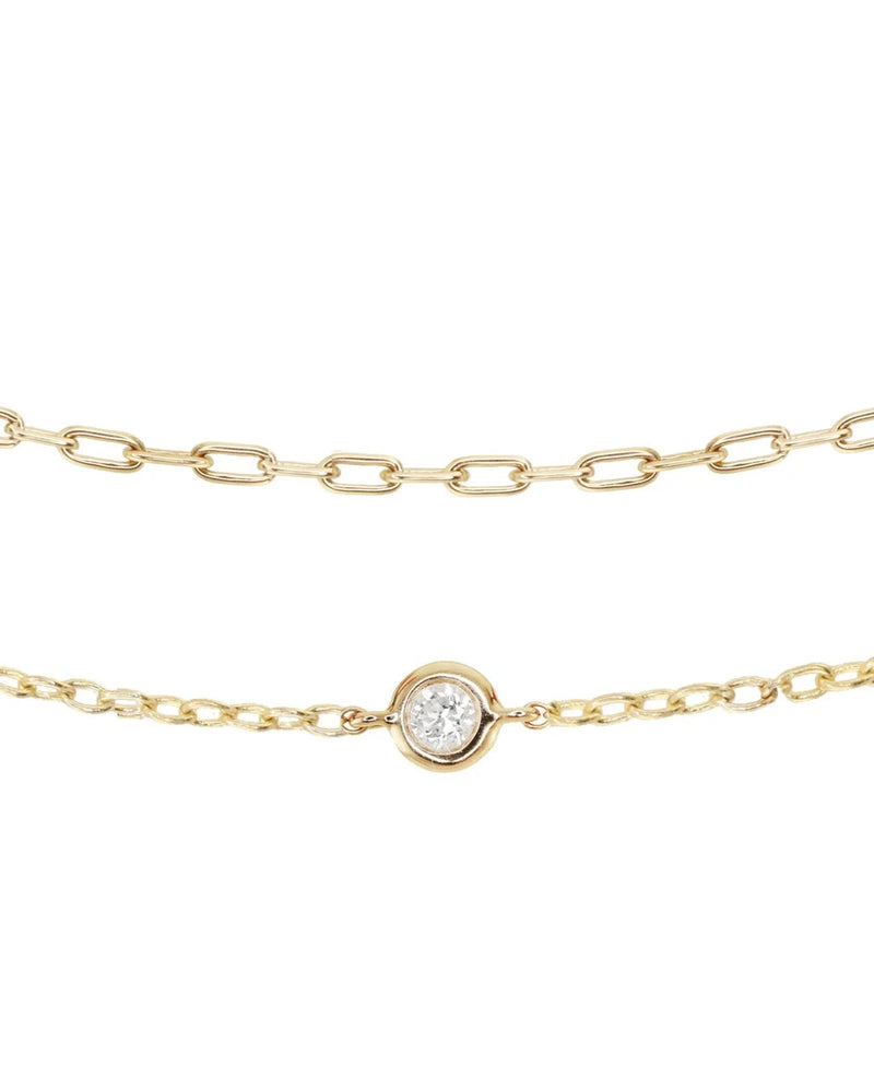 Two delicate gold chain necklaces—one with oval links, the other featuring a round diamond bezel—pair beautifully with the Luna Skye 14kt gold two row diamond bezel chain bracelet or your favorite tennis bracelet.