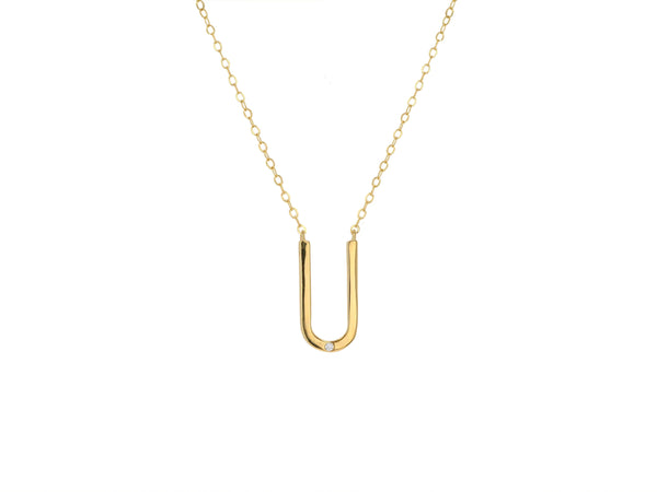 Rachel Reids Charm Holder Necklace features a delicate 14K gold chain with a U-shaped pendant, subtly adorned by a small diamond. This elegant piece, reminiscent of a diamond bar design, is beautifully displayed against a plain white background.