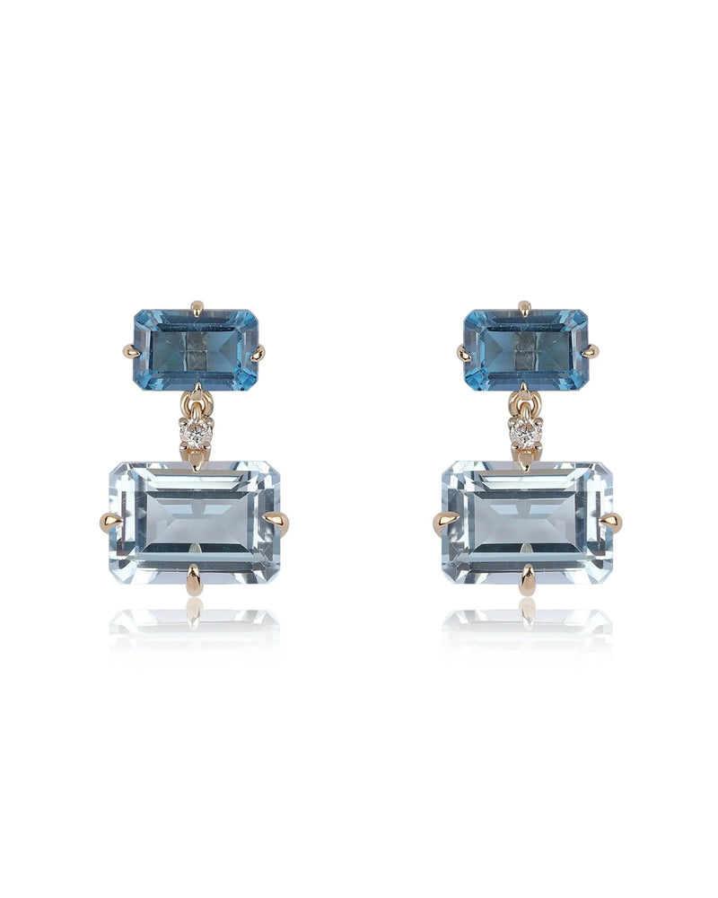 Rachel Reid’s Gemstone Drop Earrings feature rectangular blue gemstones set in 14K yellow gold, with a dark blue stone on top and a larger light blue drop below. Perfectly pair them with your favorite Gemstone Bead Necklace.