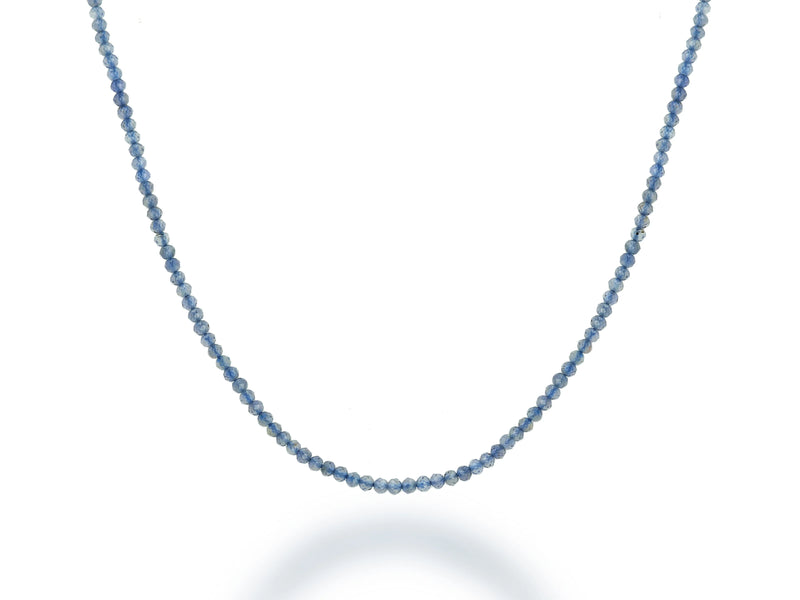 The Rachel Reid 28 Gemstone Bead Necklace features small, round faceted blue beads in a single strand with a secure lobster claw clasp, shown against a white background.