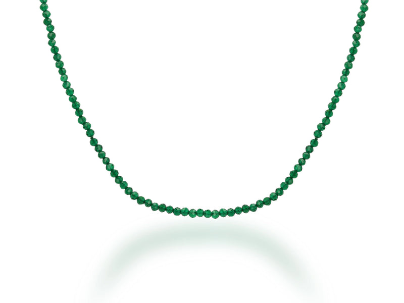 The Rachel Reid 28 Gemstone Bead Necklace features small, round green beads in a single strand with a lobster claw closure, shown on a white background with a soft shadow.