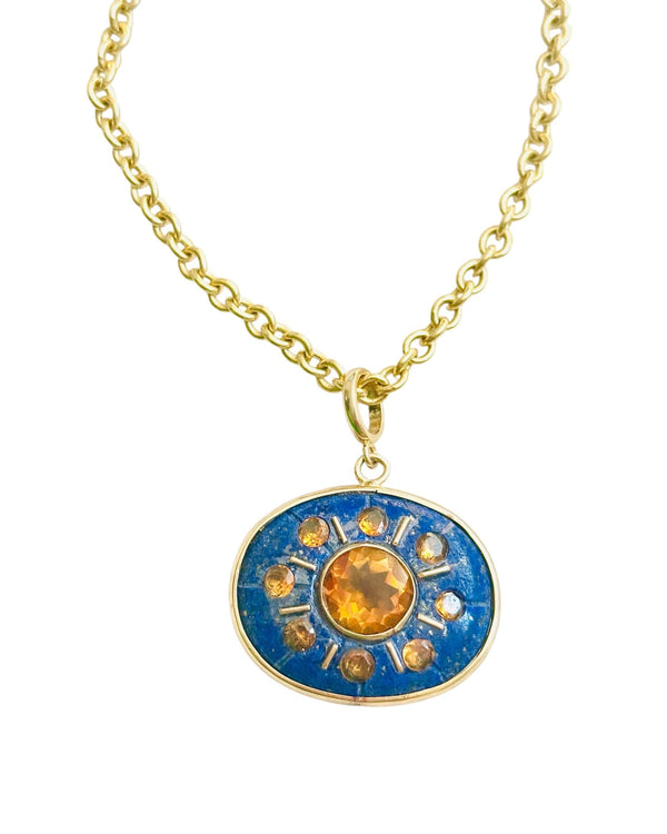 The Jen Proudman SOL Pendant - Lapis with Citrine is a handcrafted 14k gold necklace featuring a round lapis and citrine sun pendant with amber gemstones in a starburst design.