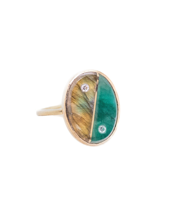 The Yin Yang Oval Ring by Karen Luvaas features a gold band with an oval face, split into brown-yellow iridescent and green stone sections, each accented with a small diamond.