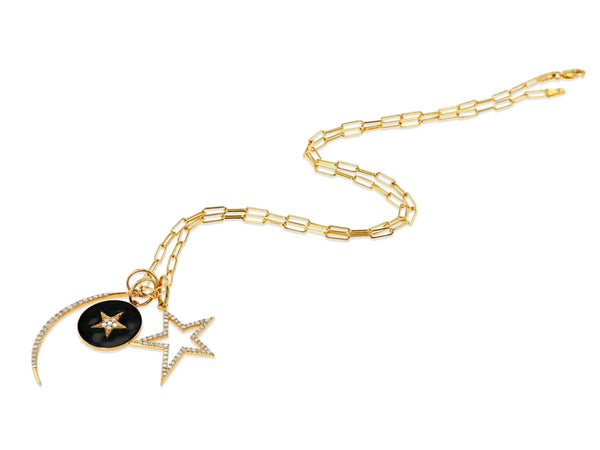 The Rachel Reid Diamond Crescent Moon Charm is a 14k yellow gold necklace featuring a diamond crescent moon, a black star pendant, and a larger diamond-outlined star. Part of our elegant charm collection. Shown on a white background.