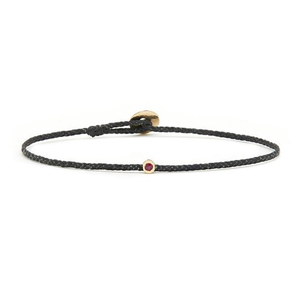 Thin black woven bracelet with Ruby