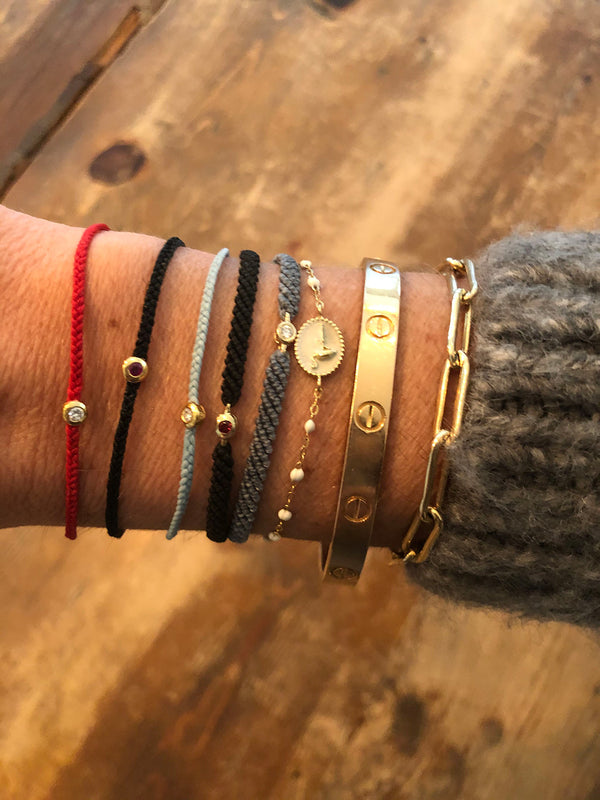 Thin black woven bracelet with Ruby