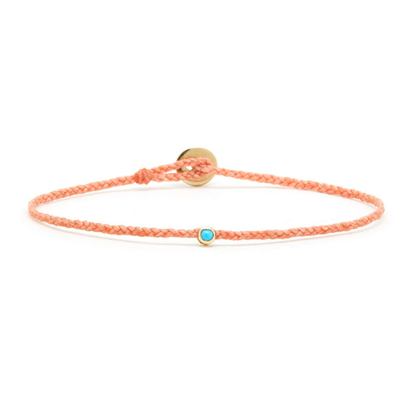 The Scosha Thin Peach Woven Bracelet with Turquoise features a central turquoise bead and round gold button clasp, crafted from recycled ocean plastic.